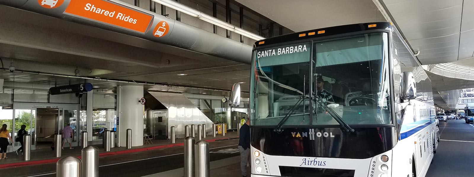 The orange sign for the pick up location for the Santa Barbara Airbus LAX Shuttle